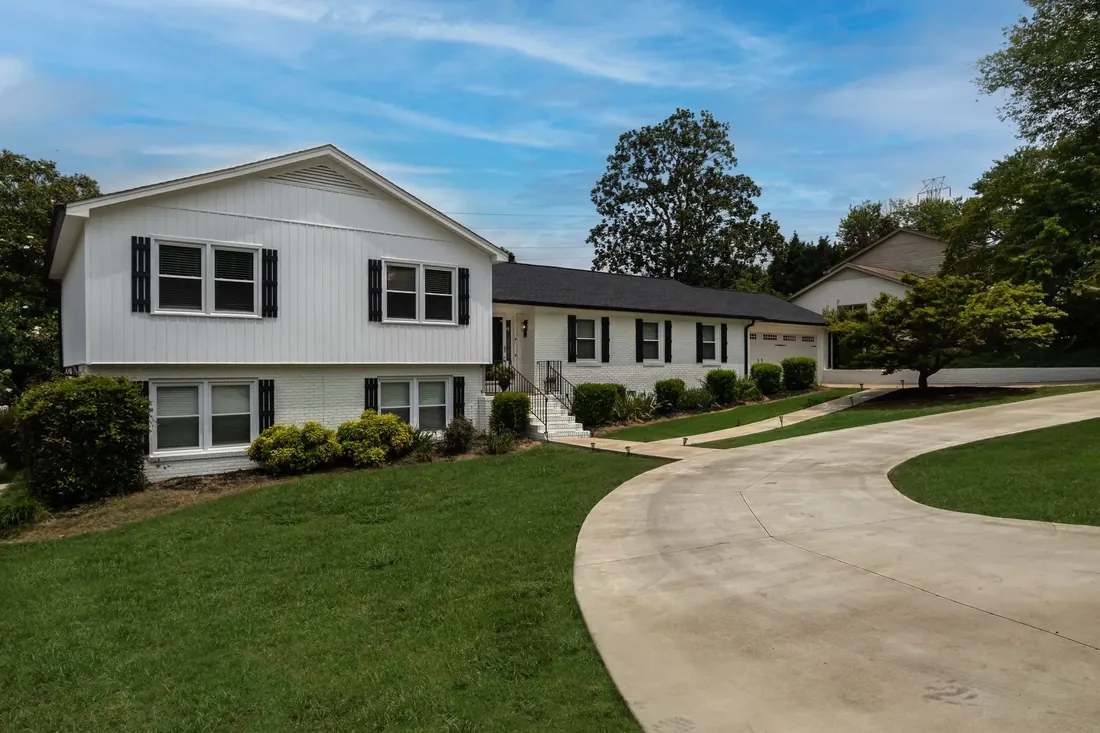A whole suburban property in one view: the house, its driveway and the full lawn around it